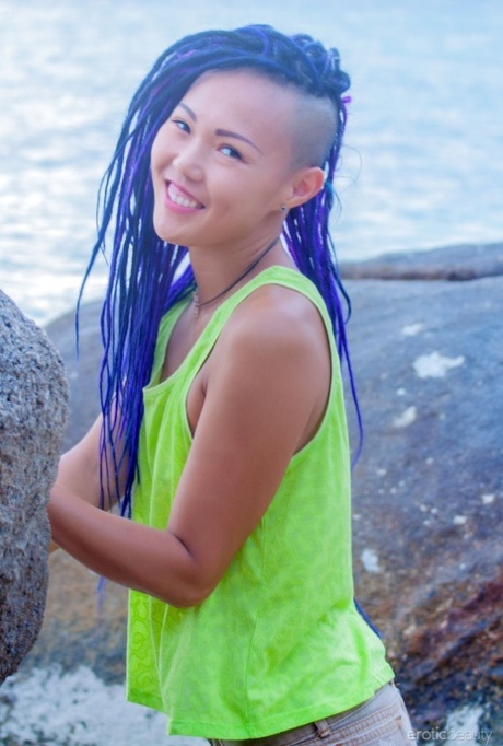 Asian teen Sweet Julie gets completely naked on sandy ground near boulders 46385057