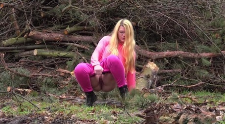 Blonde girl Delphine takes a badly needed piss near some fresh cut trees 74627208
