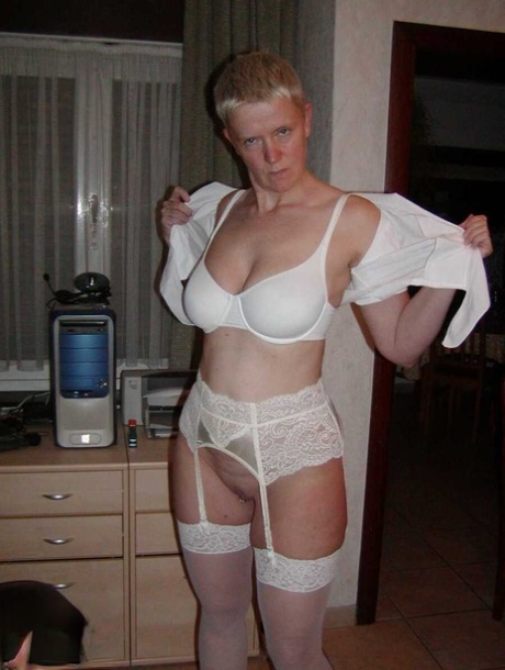 Aged blonde Tiffany Pearl holds her big tits while showing her pierced nipples 70641255