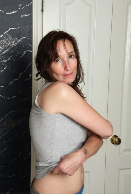Middle aged woman Celeste Carpenter undresses prior to a bubble bath 58635540