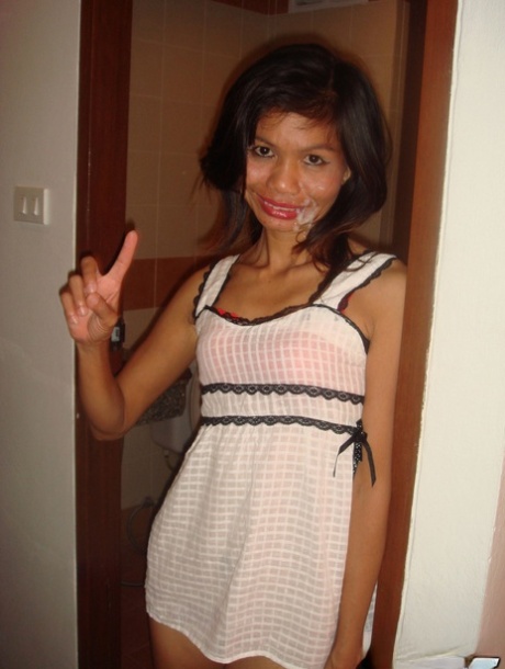 Petite Thai prostitute strips off her clothes for a sex tourist in motel room 31467115