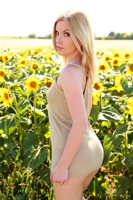 Teen model Kala Ferard sports a close up of her pussy in a field of sunflowers 53795663