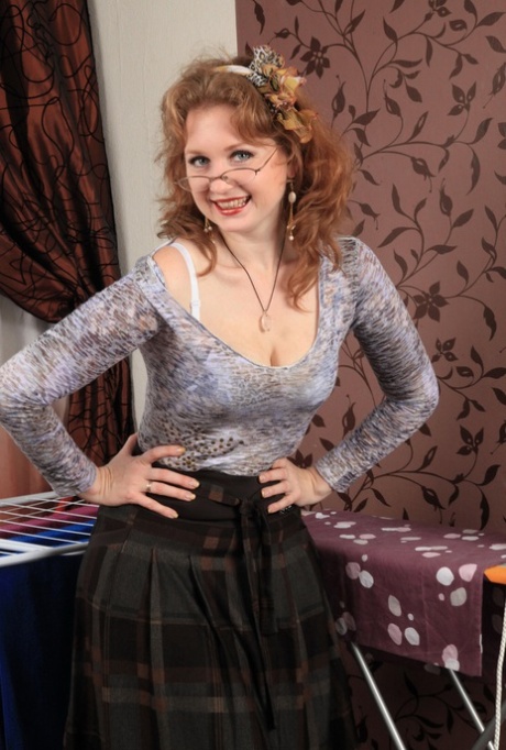 Naughty mature woman in glasses rolls of her hose to finish act of undressing 34375578