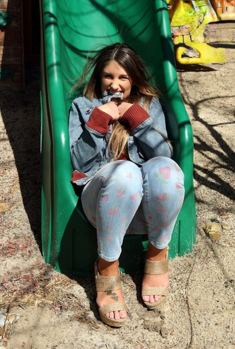 Busty amateur female August Ames spreading pussy lips apart on swing set 94042373