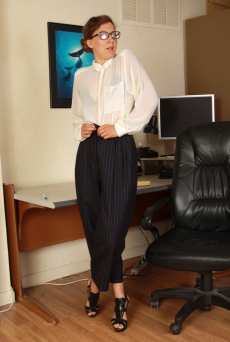 Older businesswoman in glasses bares her beaver after stripping in her office 20830305