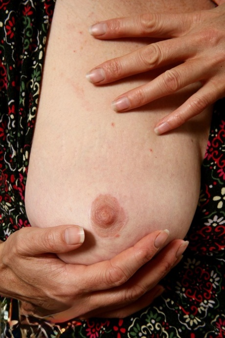 Older woman cups a boob before showcasing her hairy bush on her sofa 61800589